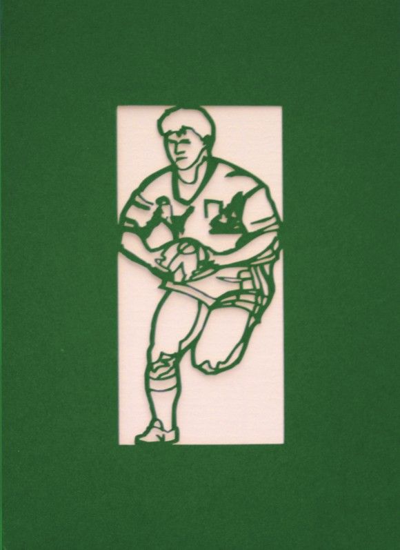 A Welsh greetings card laser cut card with a Welsh emblem representing a rugby player