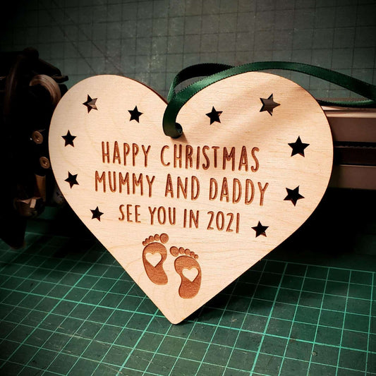 A heart shaped wooden christmas tree decoration for a new baby in 2021