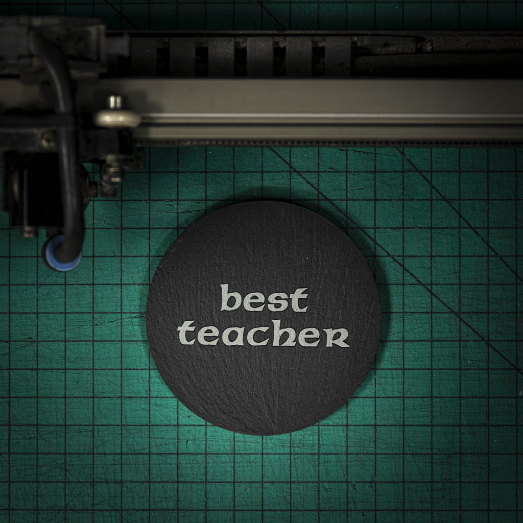 A Welsh slate coaster laser engraved with the words best teacher