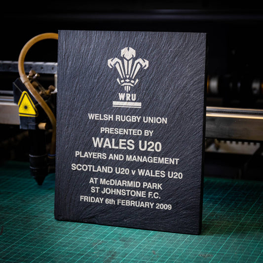 A large black laser engraved slate trophy