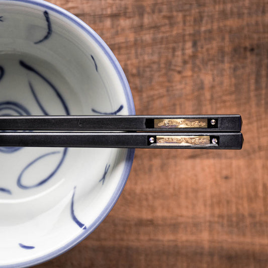 A personalised pair of black premium plastic chopsticks laser engraved