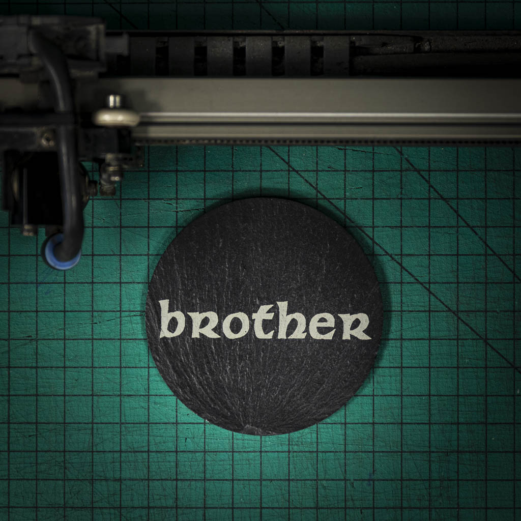 A Welsh slate coaster laser engraved with the word brother