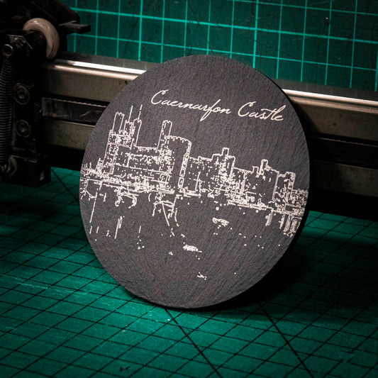 A laser engraved Welsh slate coaster with the image of Caernarfon Castles