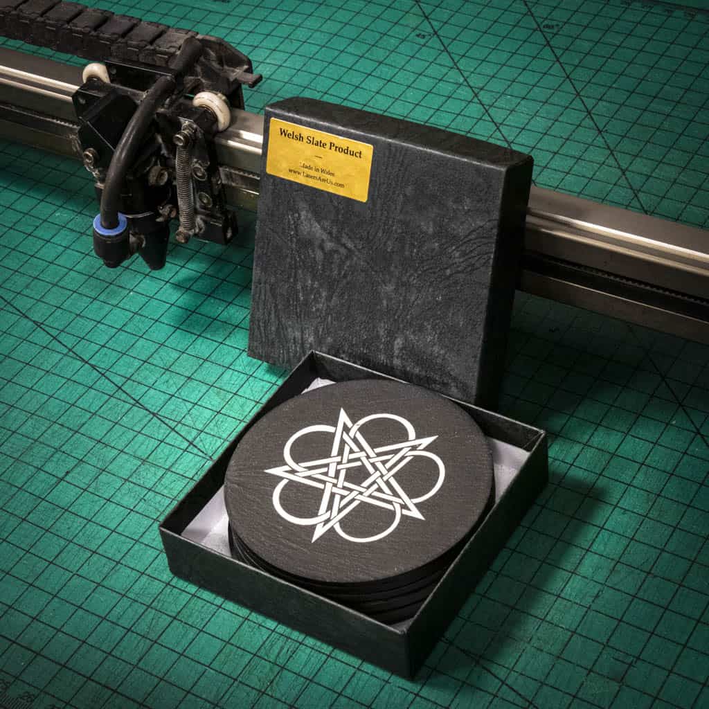 A set of laser engraved Welsh slate coasters with six different celtic knots in a decoration box
