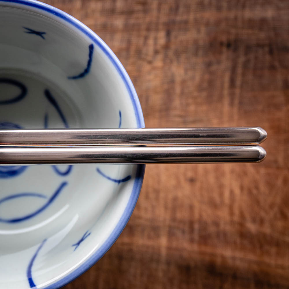 A personalised pair of children's steel chopsticks that can be laser engraved with a name