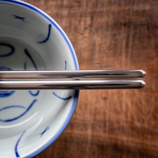 A personalised pair of children's steel chopsticks that can be laser engraved with a name