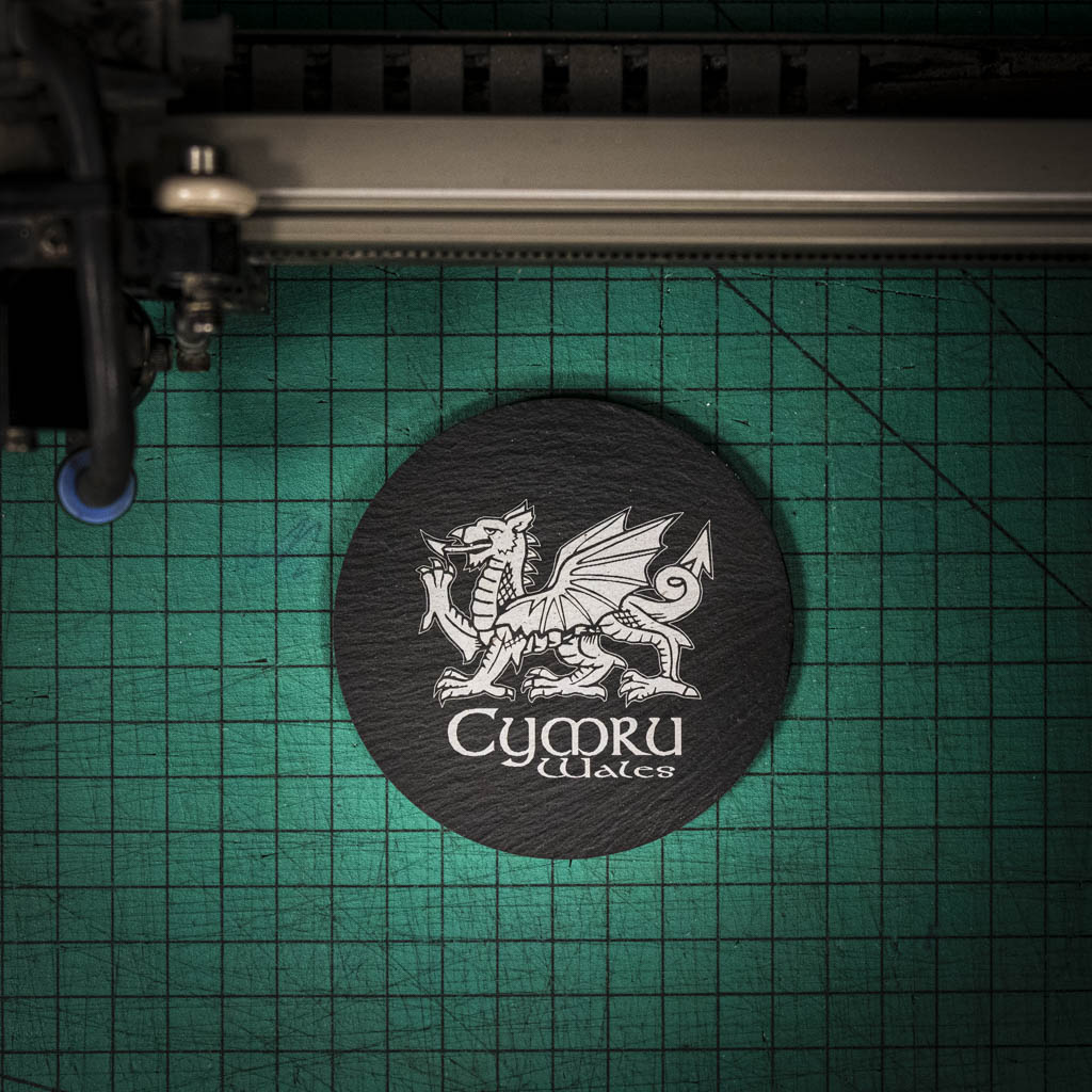 A laser engraved Welsh slate coaster with a welsh dragon and the words cymru and wales