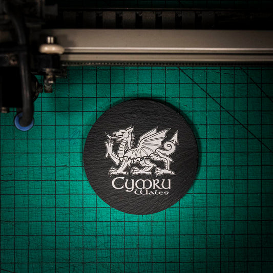 A laser engraved Welsh slate coaster with a welsh dragon and the words cymru and wales
