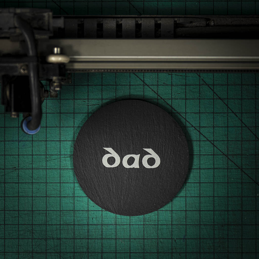 A Welsh slate coaster laser engraved with the word dad