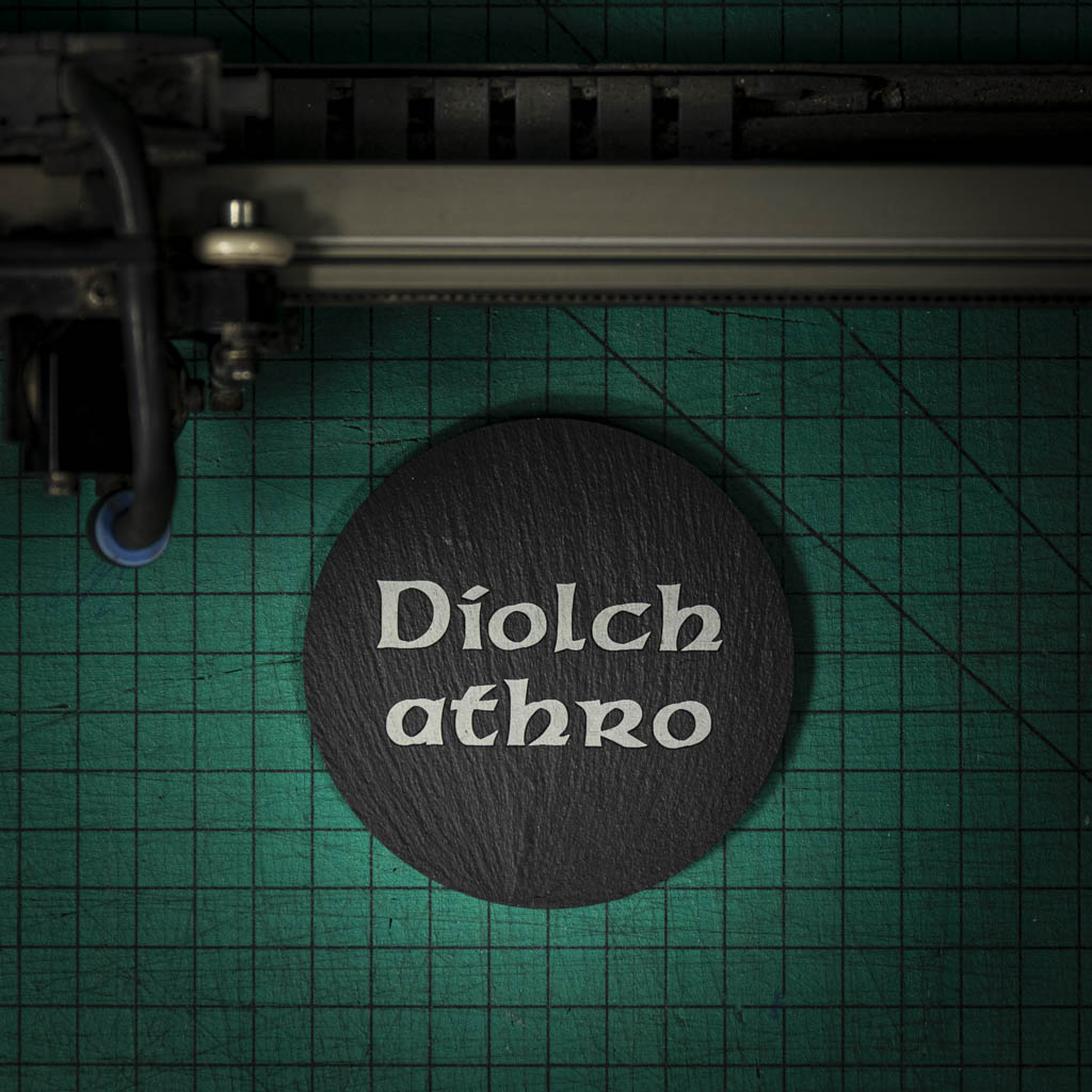 A Welsh slate coaster laser engraved with the welsh word for thank you teacher diolch athro