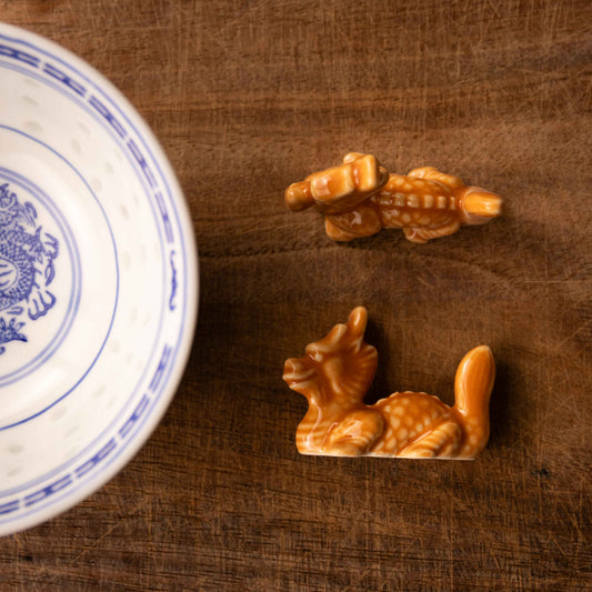 An orange-brown dragon chopstick rest.