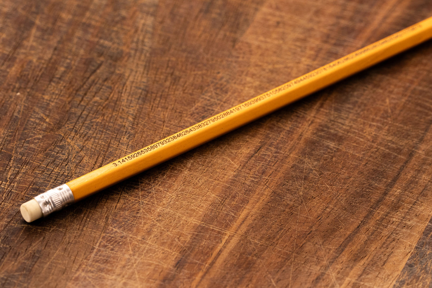 A yellow pencil that is engraved with the irrational number Pi up to 100 decimal places