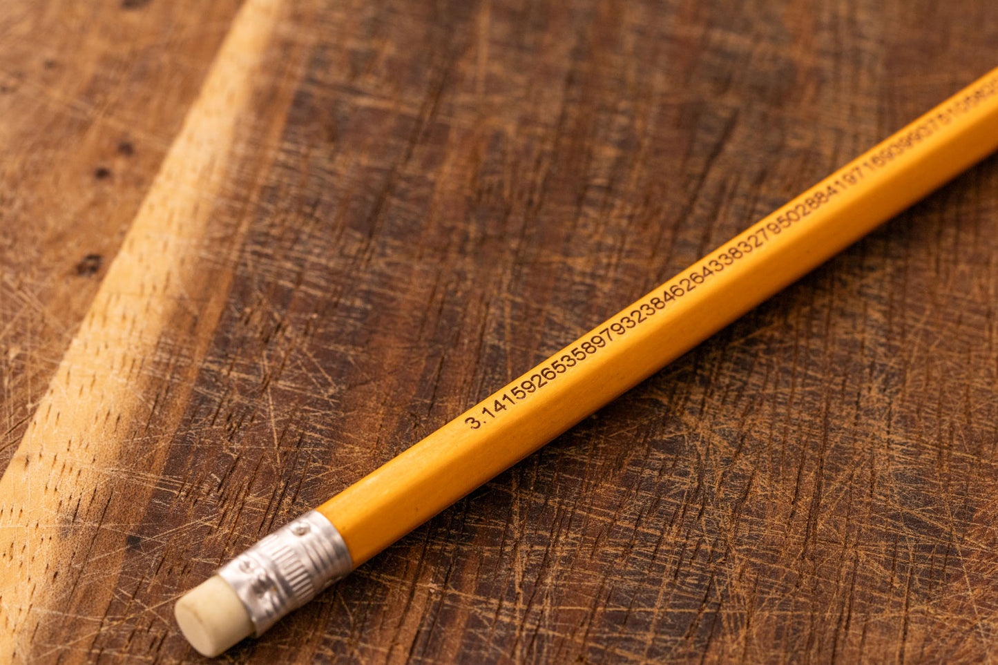 A yellow pencil that is engraved with the irrational number Pi up to 100 decimal places