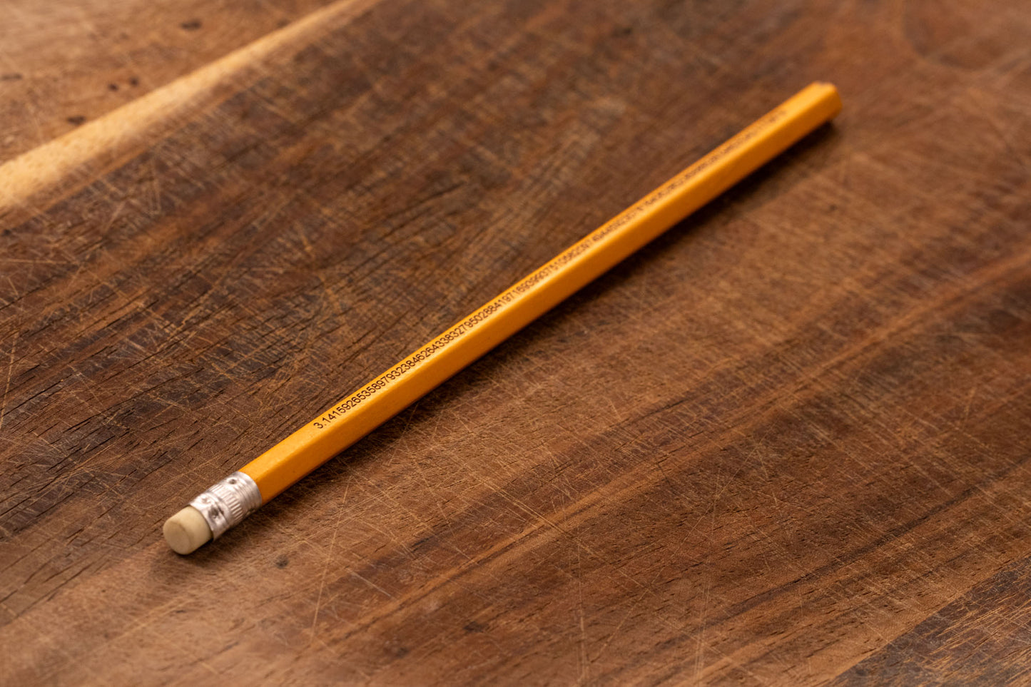 A yellow pencil that is engraved with the irrational number Pi up to 100 decimal places