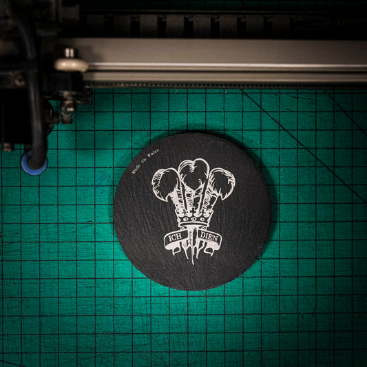 A laser engraved Welsh slate coaster with the welsh three feathers