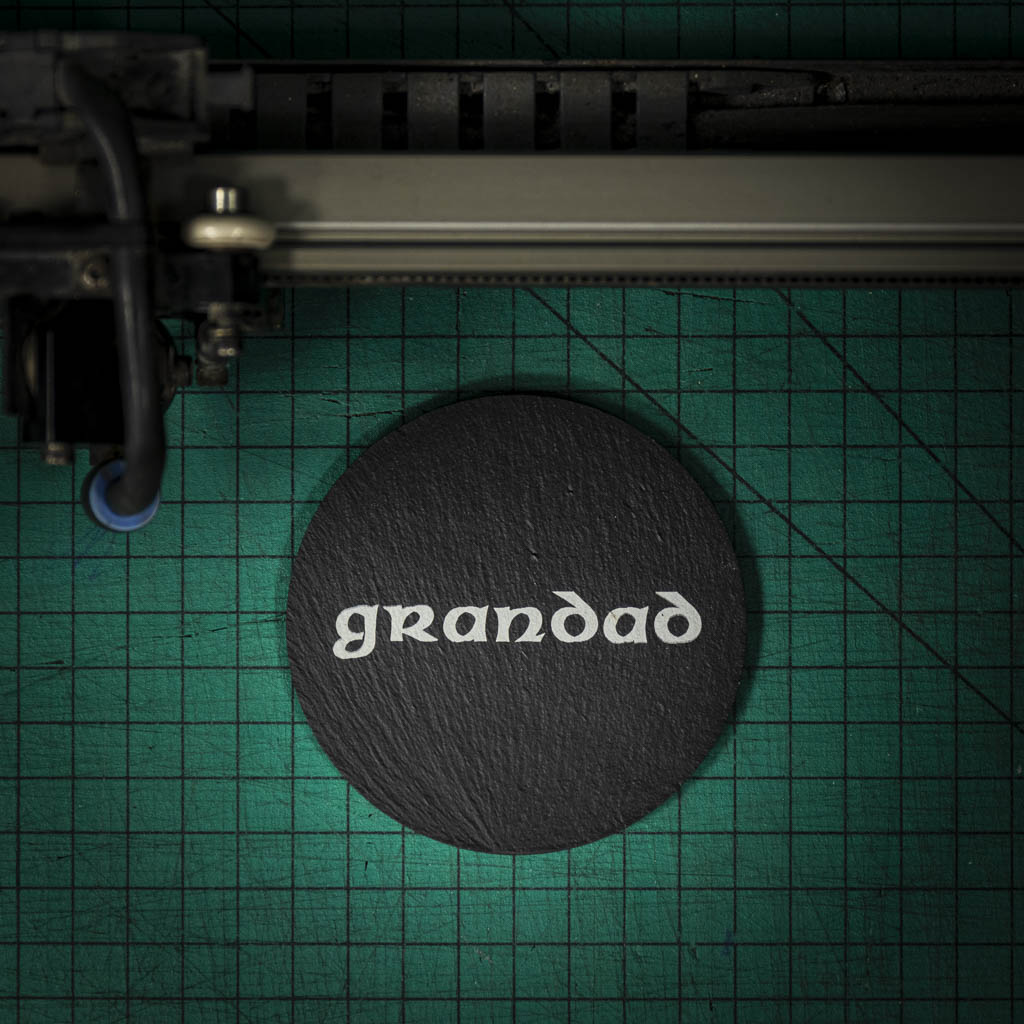 A Welsh slate coaster laser engraved with the word grandad