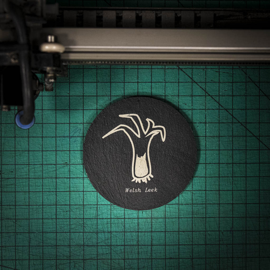 A laser engraved Welsh slate coaster with a welsh leek