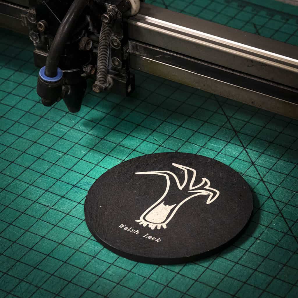 A laser engraved Welsh slate coaster with a welsh leek