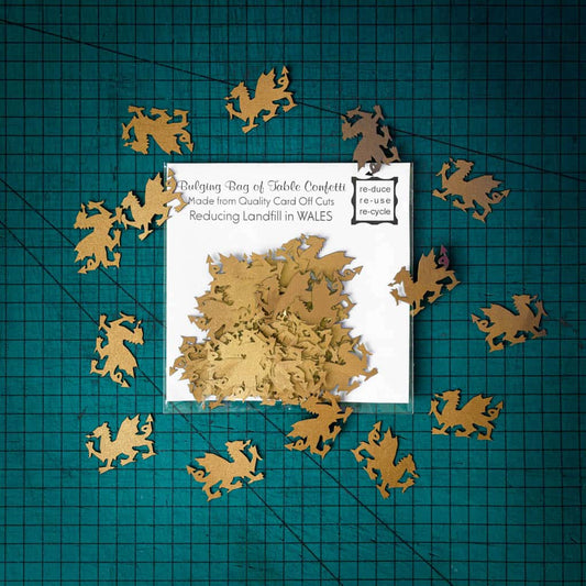 A bag of gold dragon confetti laser cut from recycled card