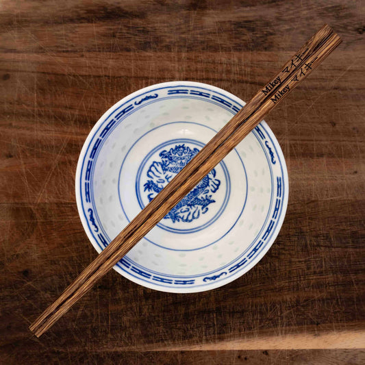 A personalised pair of Chinese Marbled wooden chopsticks laser engraved with a name in English and Chinese