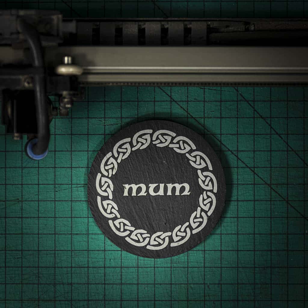 A Welsh slate coaster laser engraved with the word mum inside a celtic knot