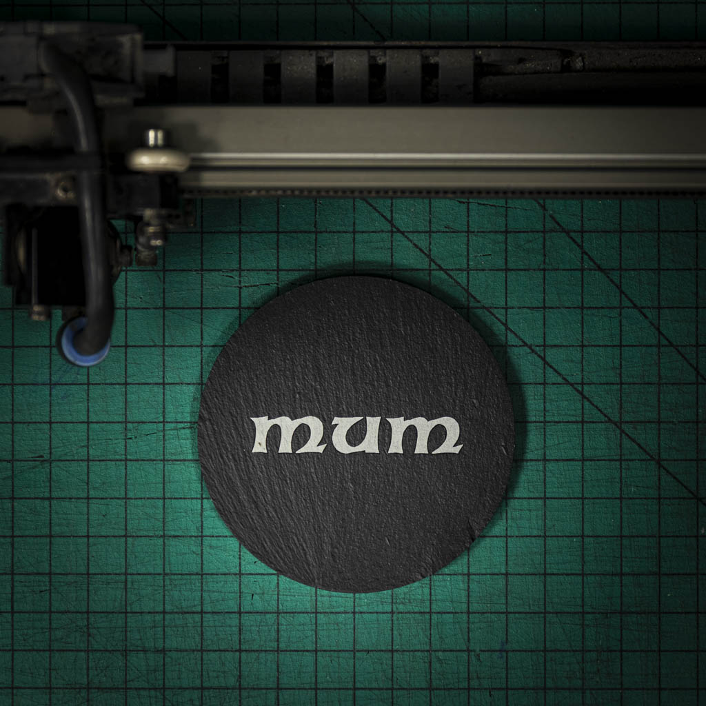 A Welsh slate coaster laser engraved with the word mum
