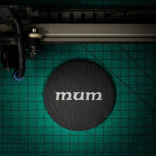 A Welsh slate coaster laser engraved with the word mum