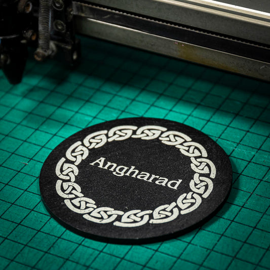 A personalised Welsh slate coaster laser engraved with a name inside of a celtic knot