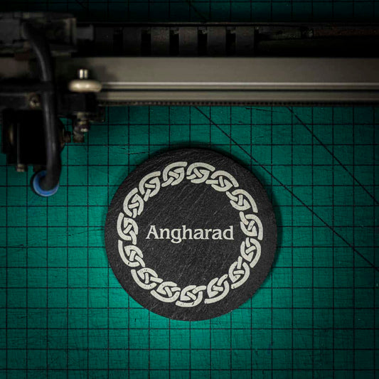 A personalised Welsh slate coaster laser engraved with a name inside of a celtic knot