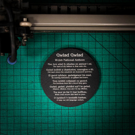 A laser engraved Welsh slate coaster with words of the welsh national anthem in English and Welsh