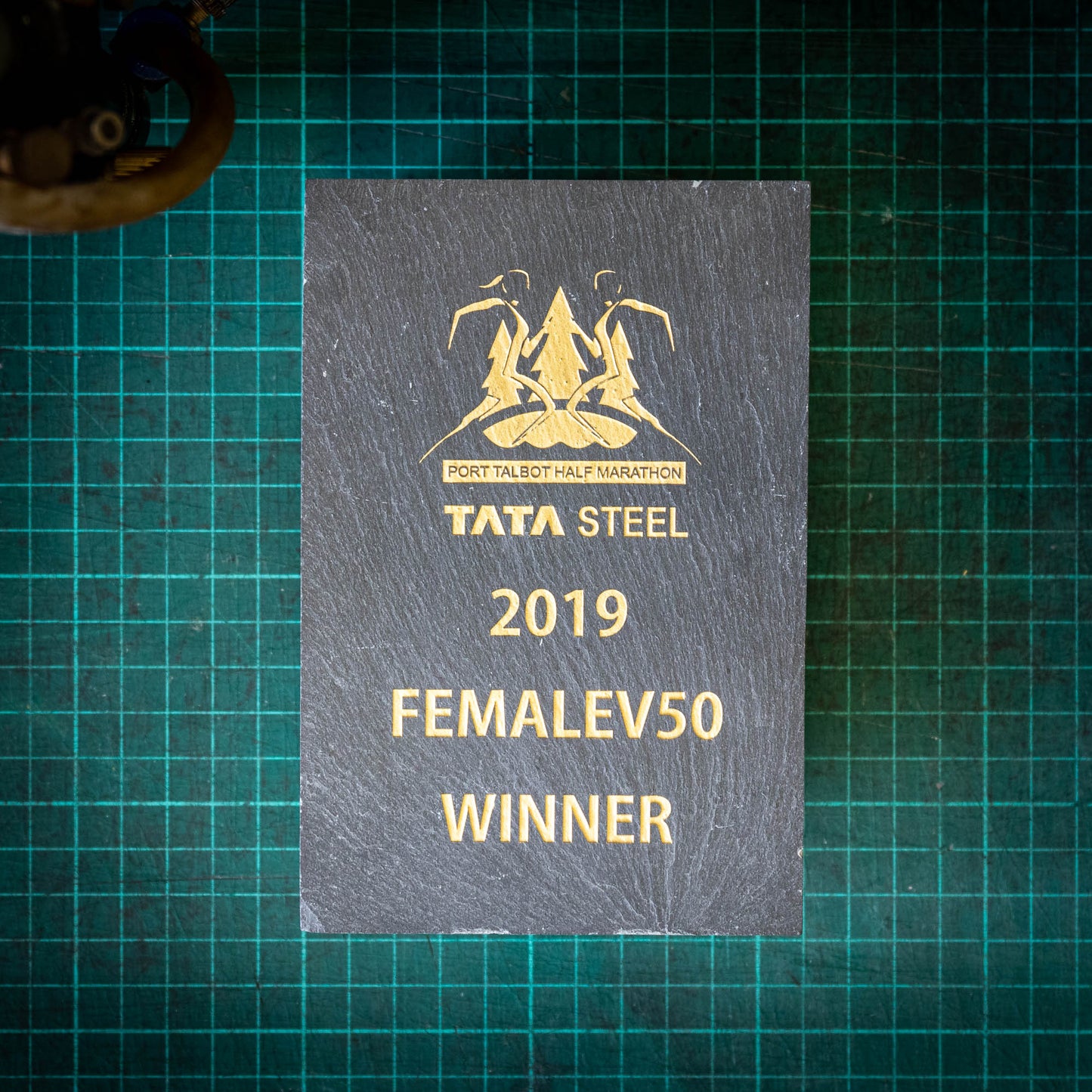 A small, natural, colour-filled slate trophy
