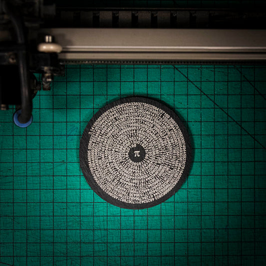 A laser engraved Welsh slate coaster with pi to 500 figures in a circle