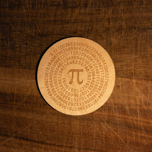 A laser engraved wooden coaster with pi to 250 figures in a circle