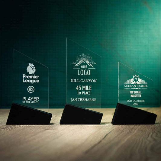 Three personalised laser engraved Perspex trophies with a Welsh Slate base
