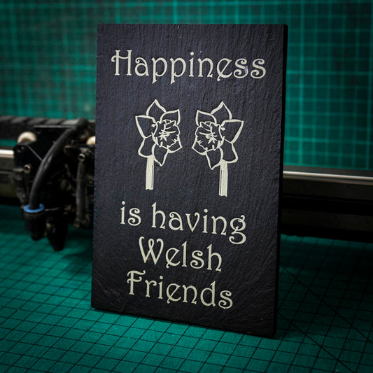 A welsh slate stand up plaque laser engraved with happiness is having welsh friends and two welsh daffodils