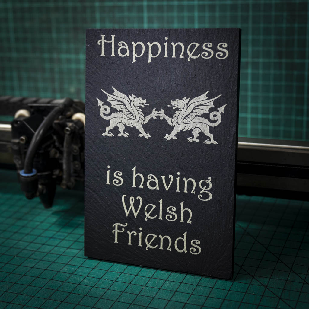 A welsh slate stand up plaque laser engraved with happiness is having welsh friends and two welsh dragons