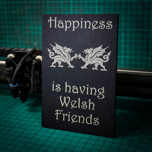 A welsh slate stand up plaque laser engraved with happiness is having welsh friends and two welsh dragons