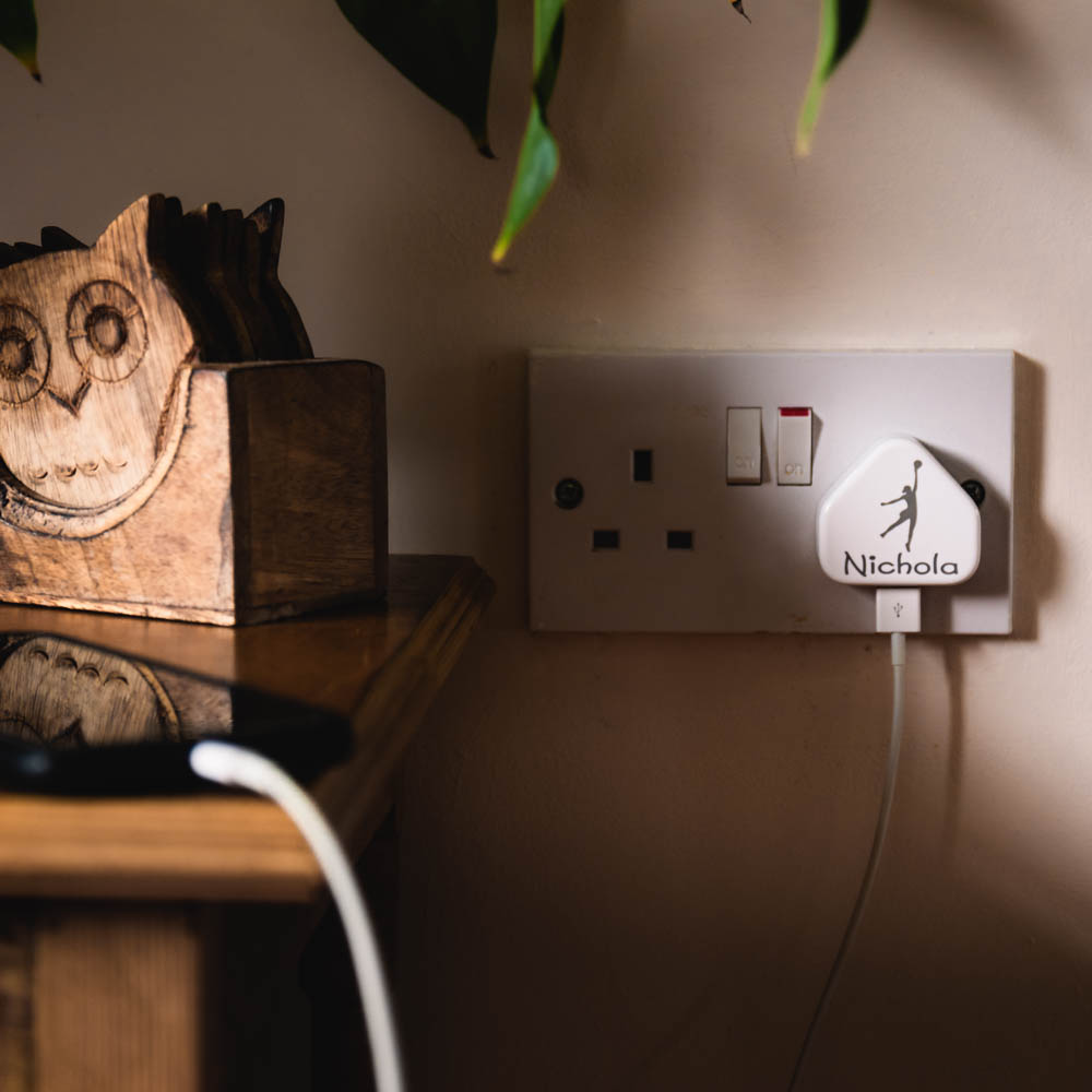 A laser engraved apple USB plug personalised with a name and image