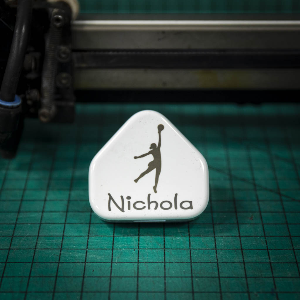 A laser engraved apple USB plug personalised with a name and image