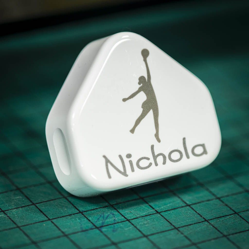 A laser engraved apple USB plug personalised with a name and image