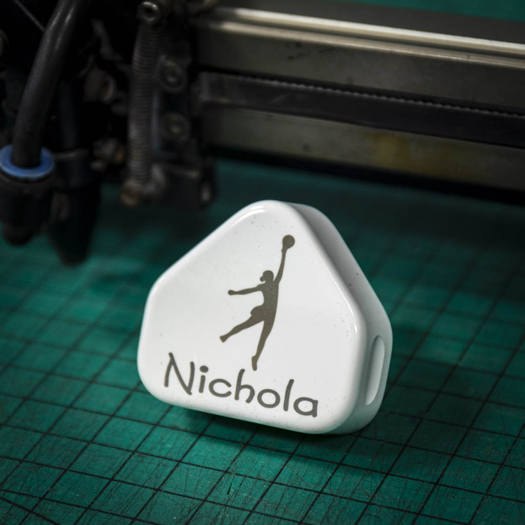 A laser engraved apple USB plug personalised with a name and image