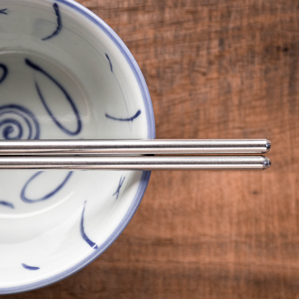 A personalised pair of rounded steel chopsticks that can be laser engraved with a name
