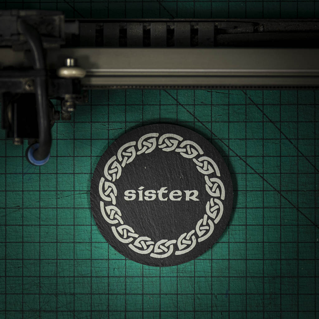 A Welsh slate coaster laser engraved with the word sister inside a celtic knot