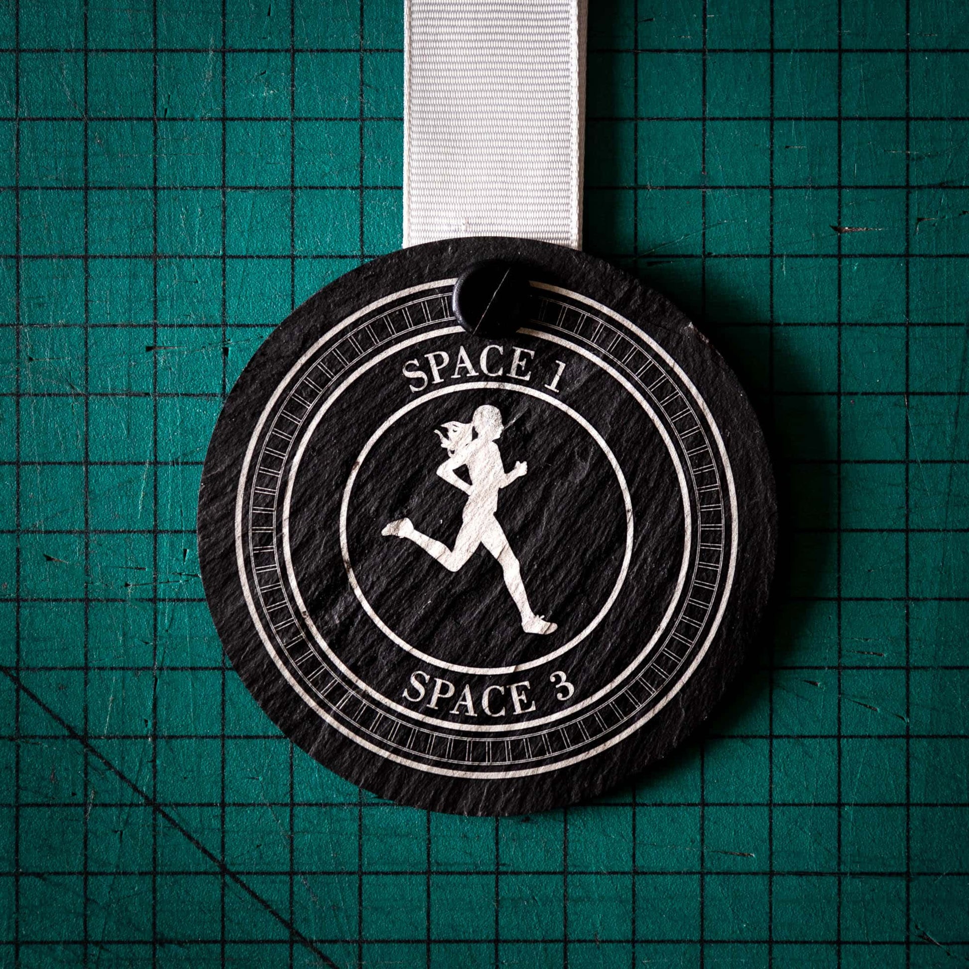 A personalised laser engraved Welsh slate sports medal