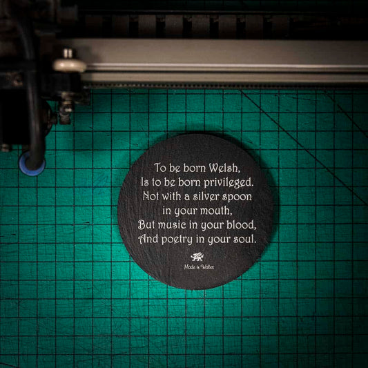 A laser engraved Welsh slate coaster with a poem about being born welsh