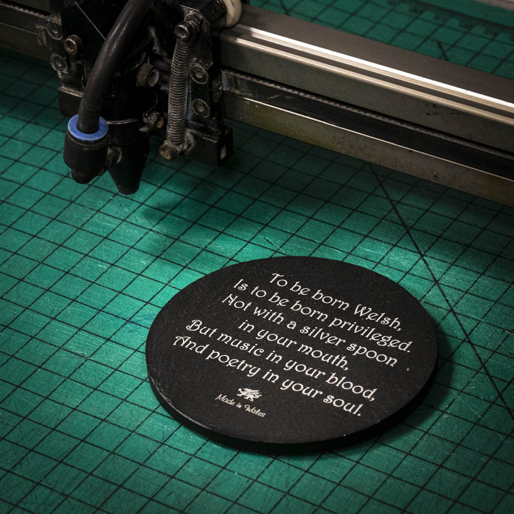 A laser engraved Welsh slate coaster with a poem about being born welsh