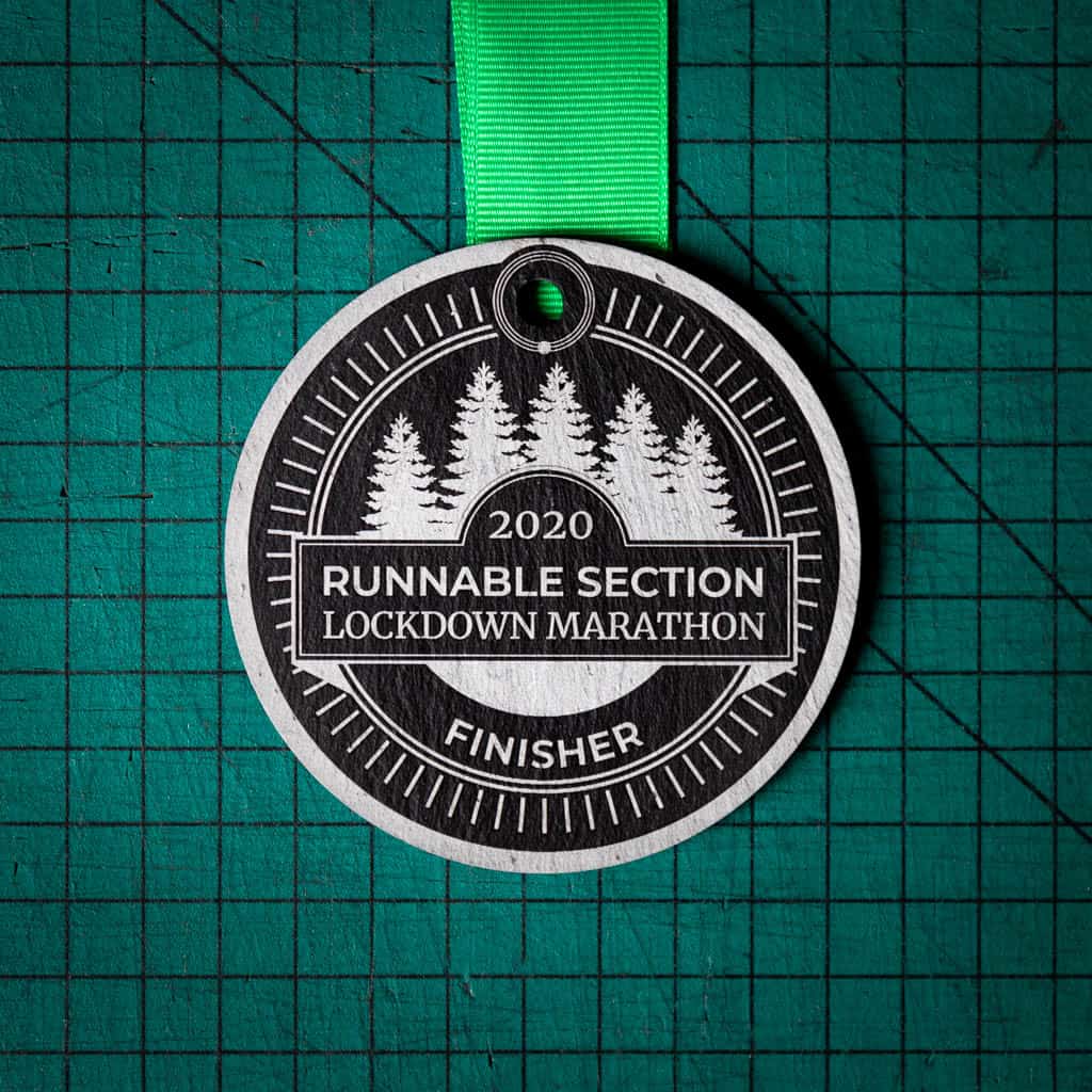 A personalised laser engraved Welsh slate running medal