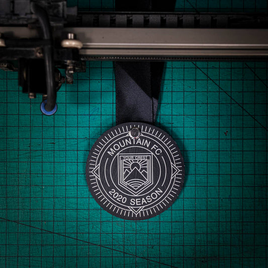 A personalised laser engraved Welsh slate running medal
