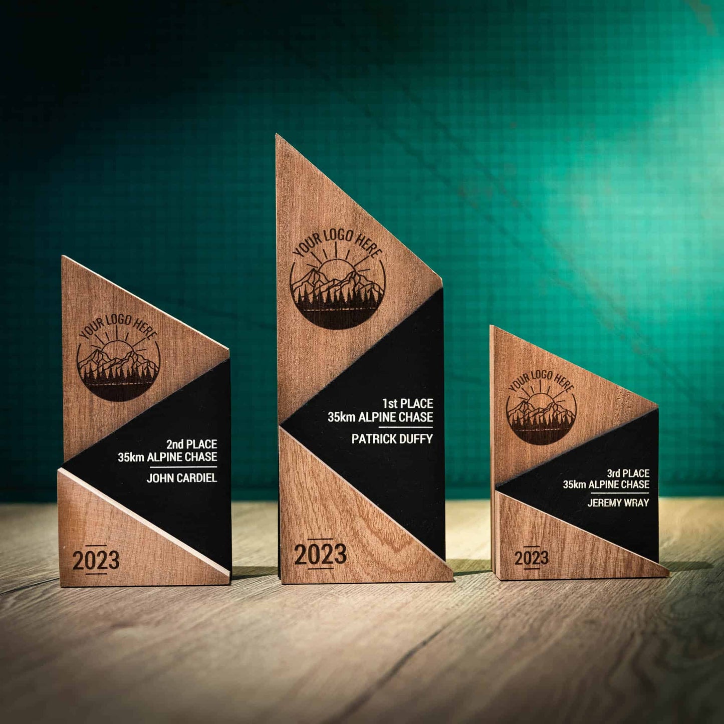 A small, medium and large laser engraved, eco-friendly, wooden and slate Peak trophy