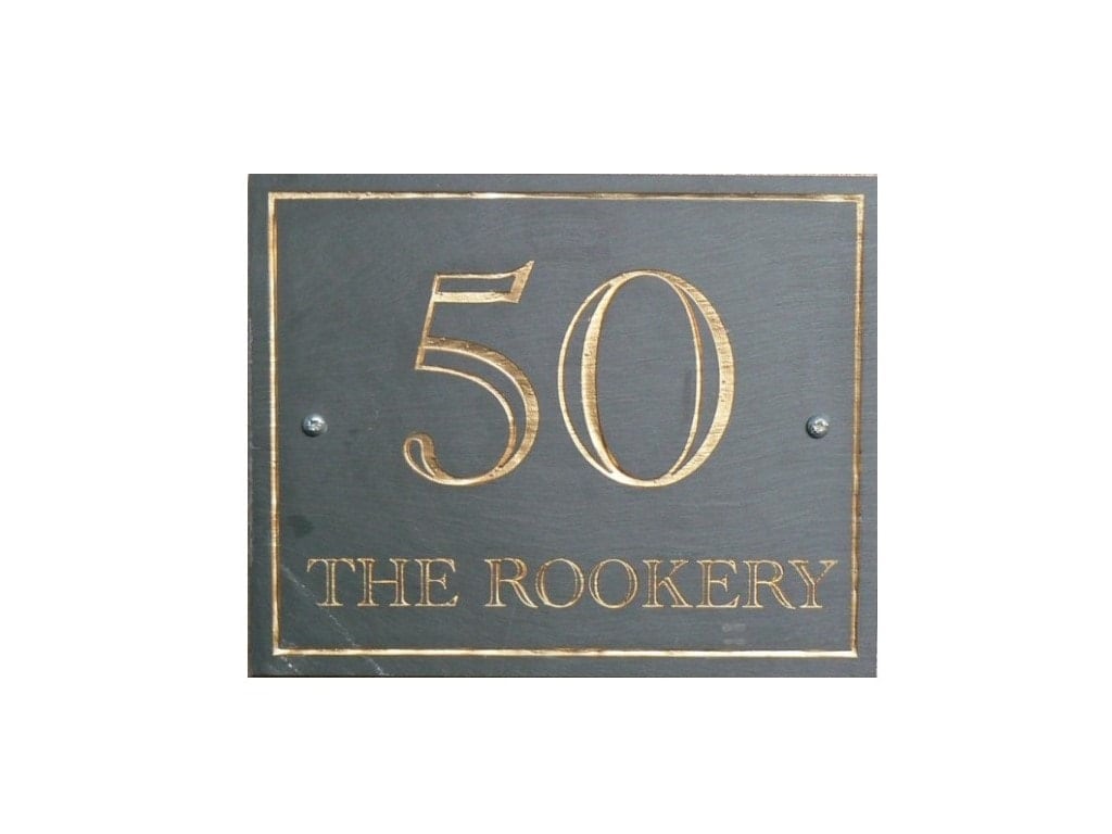 A rectangular Welsh slate house plaque laser engraved with a house number, house name and a border and colour filled in gold